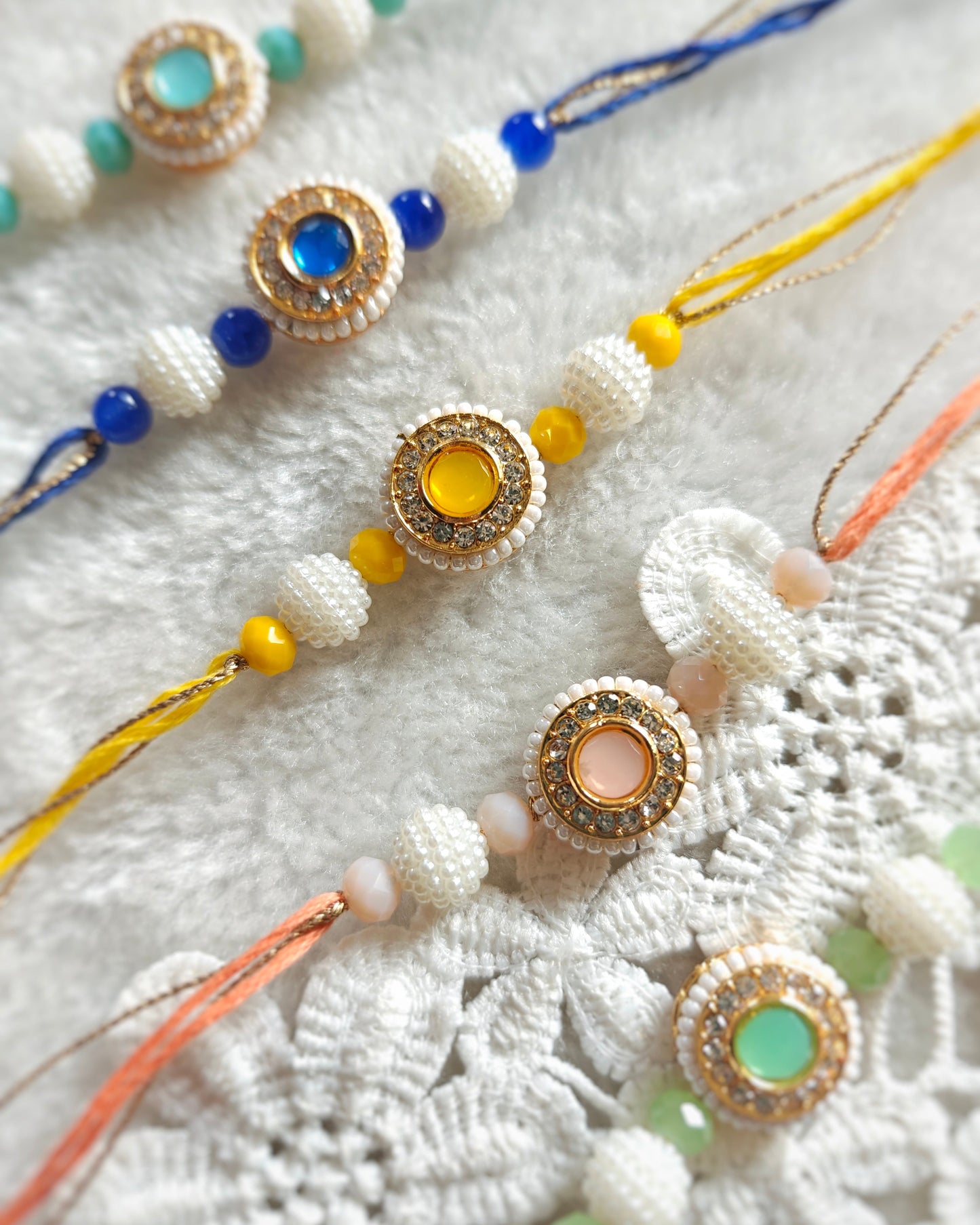 minimal kundan stone rakhi in multiple colors with bead accents elegant designer rakhi for brother
