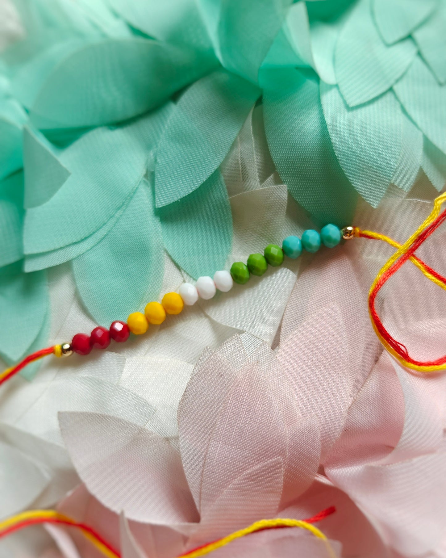 jain flag rakhi with colorful beads minimal handmade rakhi for brother