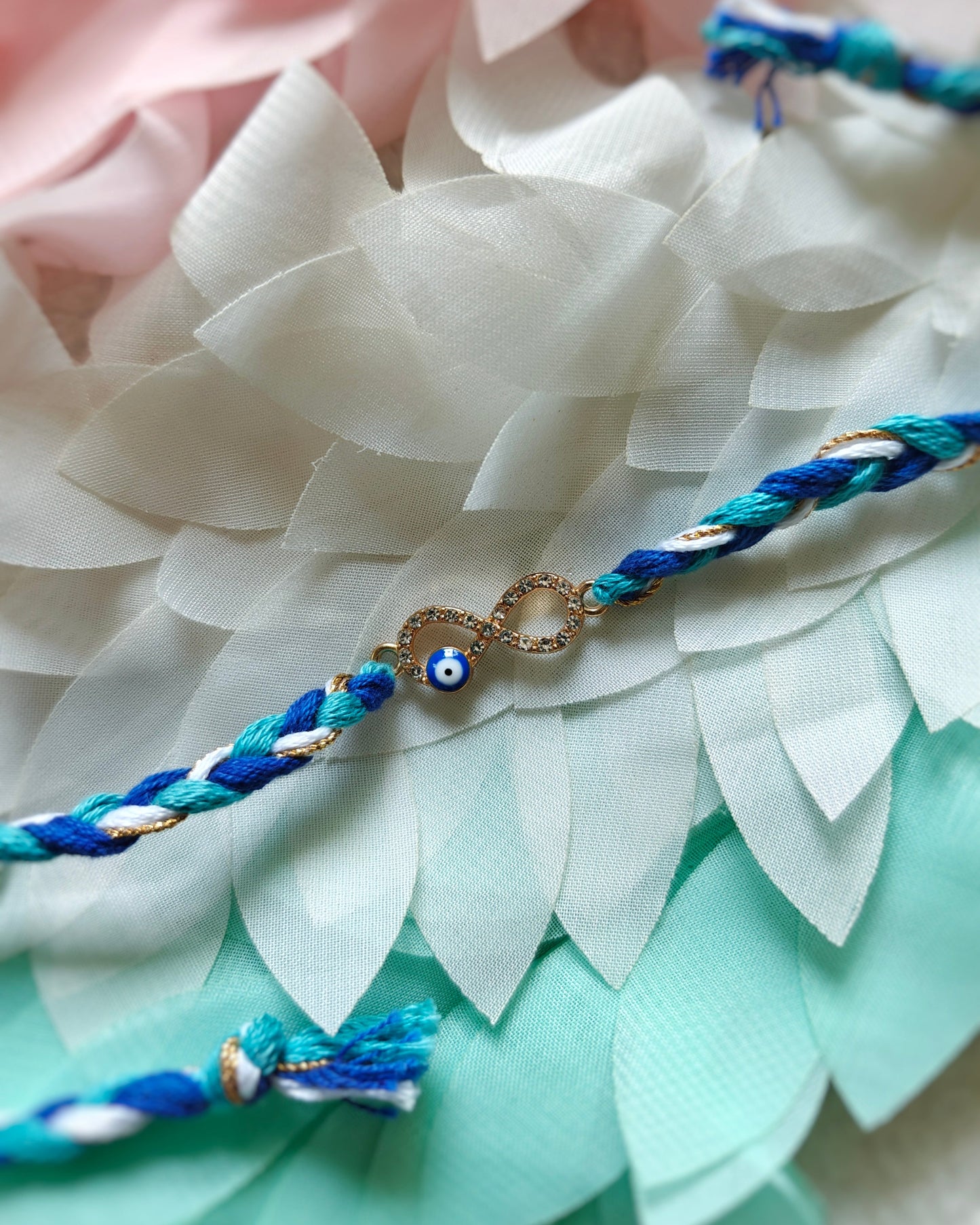 infinity evil eye rakhi for brother minimal premium rakhi with blue and gold thread