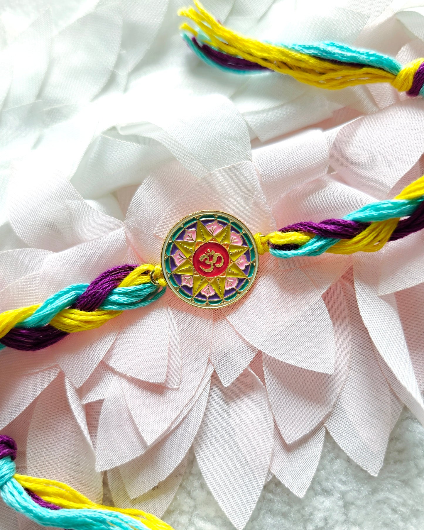 om mandala rakhi with colorful thread spiritual designer rakhi for brother