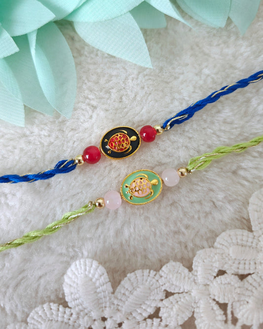 Minimal tortoise rakhi with oval charm, bead accents and twisted threads on soft background
