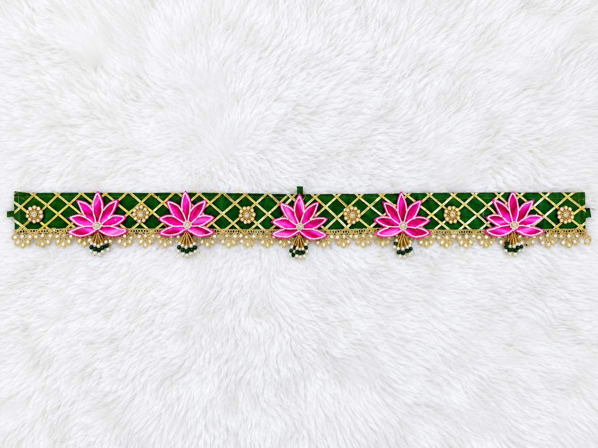 Handmade green festive toran with pink lotus motifs and lace detailing for door décor